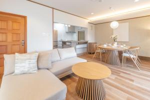 a living room with a couch and a table at KINOTOMI 近江舞子 - Self Check-In Only in Otsu