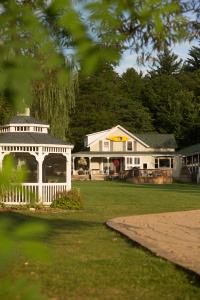 a large white house with a gazebo at Shore Meadows Lodge LLC in Lake George
