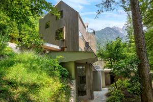 a house in the woods with a green roof at Jasna Manison in Kranjska Gora