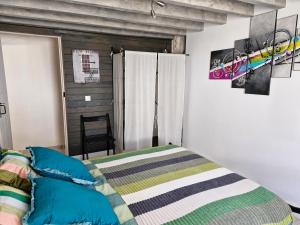 a bedroom with a bed and a wooden wall at Chambre d'hote in Saint-Dizant-du-Gua