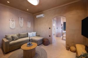 a living room with a couch and a table at Gama luxury living in Symi