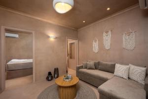 a living room with a couch and a table at Gama luxury living in Symi