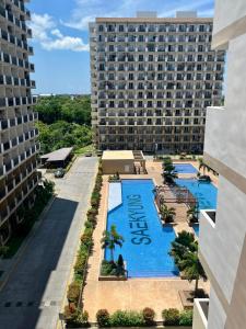 an aerial view of a large building with a swimming pool at TheSimsCozyPlace in Lapu Lapu City