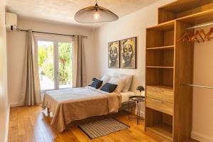 a bedroom with a bed and a large window at Villa Lisa Porto-Vecchio in Porto-Vecchio +24 photos