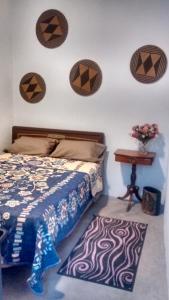 a bedroom with a bed and a table at Colibrí B&B in Mexico City
