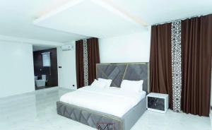 a bedroom with a large bed and a bathroom at Enak homes in Miocho