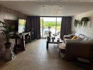 a living room with a couch and a piano at Villa bellevue in Roquebrune