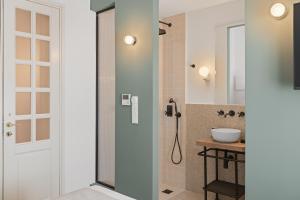 a bathroom with a shower and a sink at Morus Acropolis Boutique Hotel in Athens +49 photos