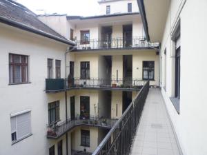 ブダペストにあるレトロ アパートメントのバルコニー付きの2棟の間の路地