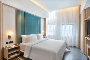 Postel nebo postele na pokoji v ubytování VIVERE Hotel, ARTOTEL Curated