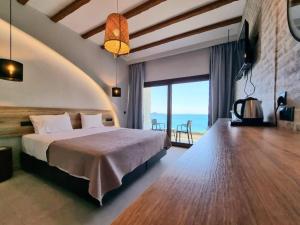 a bedroom with a bed and a view of the ocean at Enjoy Lichnos Bay Village, Camping, Hotel and Apartments in Parga +143 photos