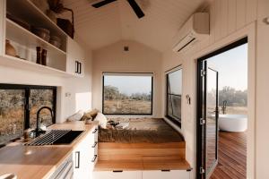 a tiny house with a large window and a sink at Tiny Harry in Mudgee