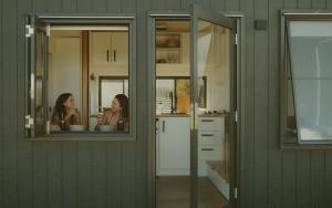 two women in a kitchen looking in a mirror at Tiny Harry in Mudgee +14 photos