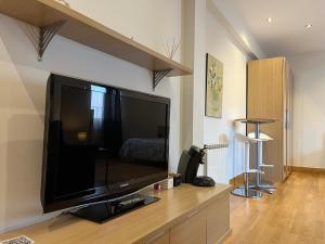a living room with a large flat screen tv at Estudios Blanmart in Santander
