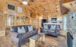 a living room with two leather couches and a table at Lifes a Bear in Gatlinburg