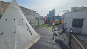 a small sail boat sitting on a wooden deck at Pohang Poderosa Blue Guesthouse in Pohang +14 photos