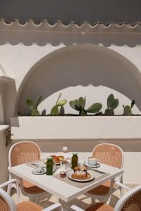 a white table with a plate of food on it at Maison Sirolo in Sirolo +181 photos