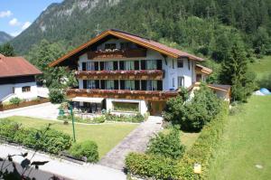 a large house in the middle of a mountain at Anna's Appartements in Pertisau