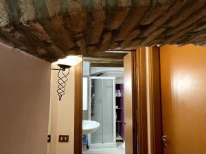 a room with a ceiling and a bathroom with a sink at Dimora i Laghi Tra Como, Lecco e Bellagio in Erba +17 photos