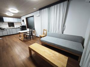 a living room with a couch and a table at ZYZ Fujimidai House練馬一户建 in Tokyo