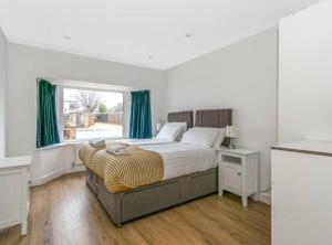 a bedroom with a large bed and a window at Sea Breeze in Poole