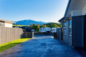 a driveway next to a house with a rv parked at Mountain View - Kaikoura Holiday Home in Kaikoura