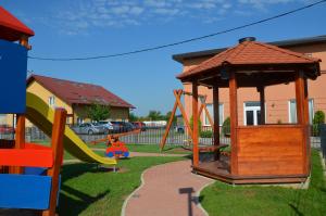 a playground with a slide and a gazebo at Hotel Phoenix in Velika Gorica