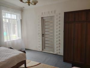 a bedroom with a bed and a closet and a window at Gyumri in Gyumri