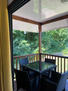 a screened in porch with a table and chairs at Bungalow 6 'Mata'i' in Parea +5 photos