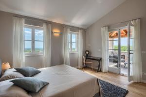 a bedroom with a large bed and a balcony at Villa Julia - Luxury villa with sea view in Razvala +55 photos