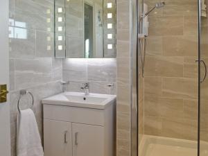 a bathroom with a sink and a shower at Sheerwater in Appledore
