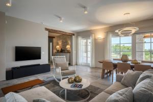 a living room with a couch and a table at Villa Julia - Luxury villa with sea view in Razvala