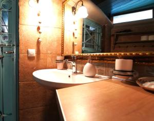 a bathroom with a sink and a mirror at ART HOUSE in Parga +17 photos
