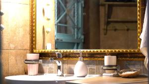 a bathroom with a sink with a mirror and a sink at ART HOUSE in Parga