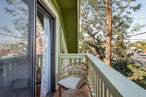 a chair on a balcony with a view of a street at Silver Triangle Oasis with Verdant Backyard in Los Angeles