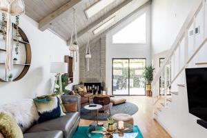 a living room with a couch and a table at Silver Triangle Oasis with Verdant Backyard in Los Angeles