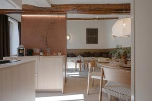 a kitchen and dining room with a table and chairs at MiHotel Le Gourguillon in Lyon