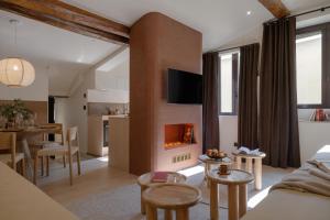 a living room with a fireplace and a table at MiHotel Le Gourguillon in Lyon