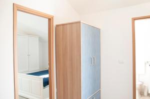 a bathroom with a wooden cabinet and a mirror at 3 Palms in Drvenik Mali