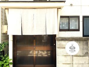 a door to a building with a white curtain over it at Traditional Japanese House -in Matsumoto Asama Onsen- in Matsumoto