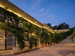 a greenhouse with plants on the side of a building at Ama Wela Living Labuan Bajo in Mbura