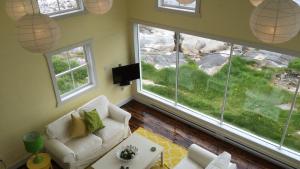 a living room with a couch and a large window at The Old Salt Box Co. - Aunt Christi's in Greenspond