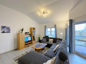 a living room with a couch and a tv at Residenz Binz - FeWo 16 in Binz