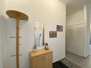 a bathroom with a mirror and a wooden dresser at Residenz Binz - FeWo 16 in Binz