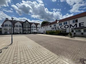 a group of buildings with a welcome sign on a street at Hotel Torgauer Brauhof in Torgau