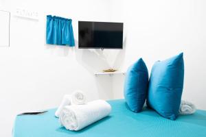 a room with blue pillows and towels on a bed at Da Giuseppina in Ercolano