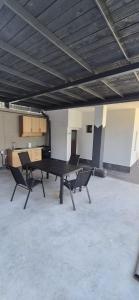a ping pong table in an empty room with two chairs at Casa Carina in Brăila