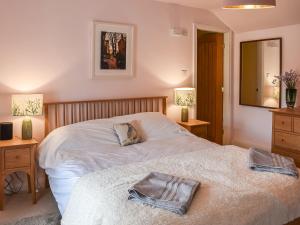 a bedroom with a bed with a dog laying on it at Wellgate in Middlesmoor