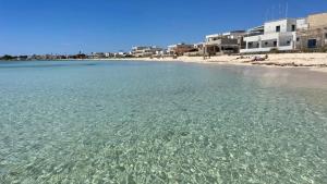 a view of a beach with crystal clear water at Salento apartment in Torre Lapillo