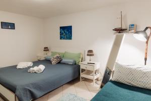 a bedroom with two beds and a table with a lamp at Tufara Villa a Mare in Polignano a Mare +17 photos